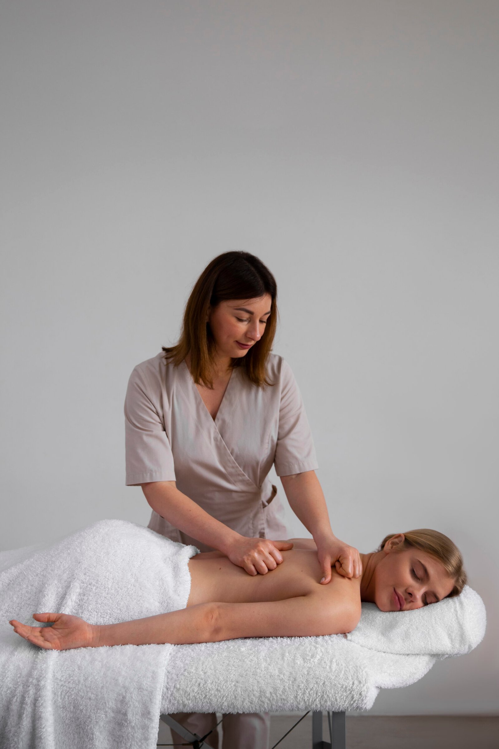 woman getting back massage from masseur
